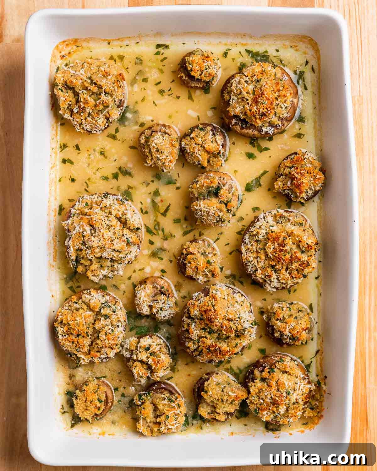 Parmesan & Herb Stuffed Mushrooms 9 Overhead shot of baking dish with cooked Italian stuffed mushrooms.