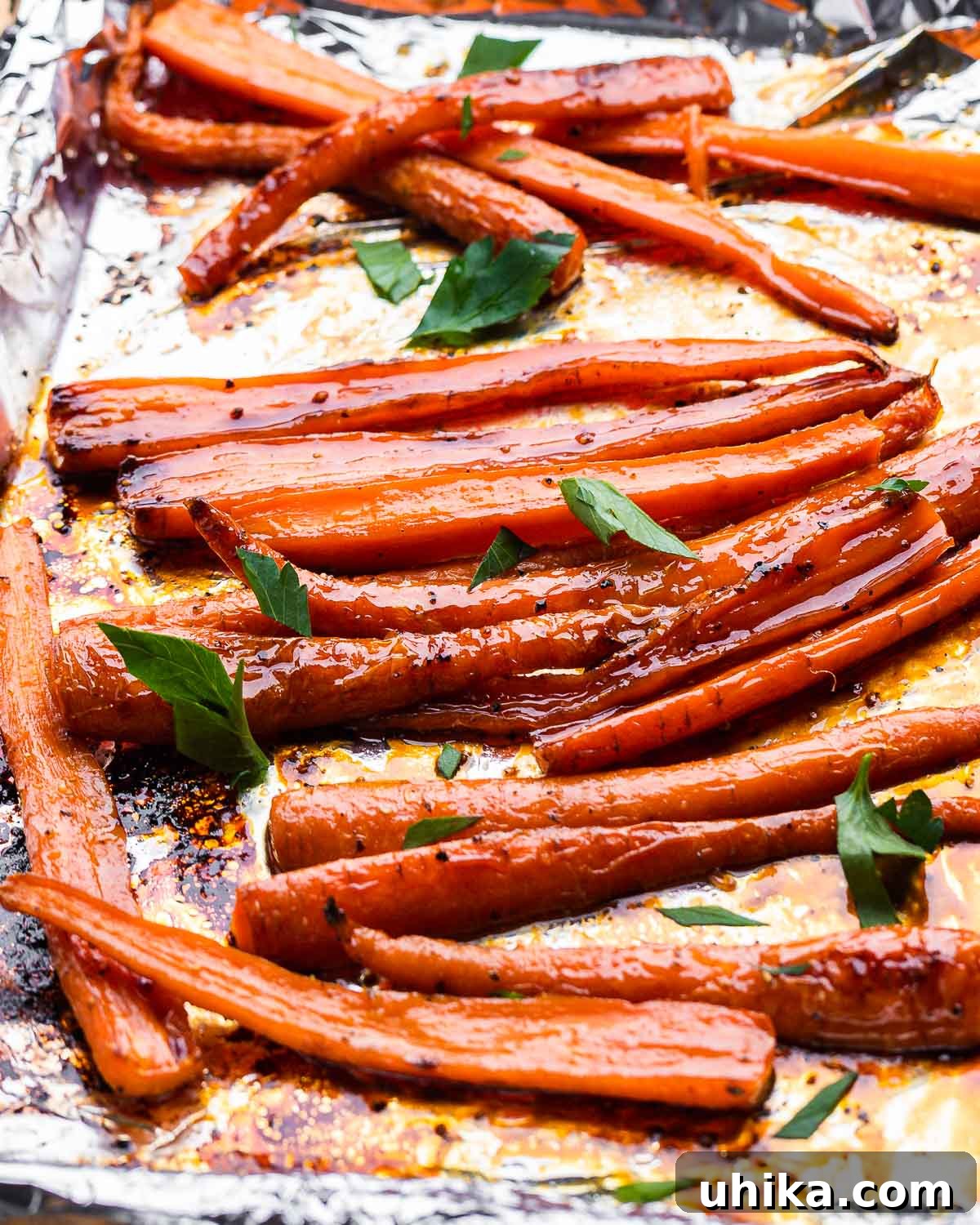 Candied Maple Carrots 6 Foil lined baking sheet with glazed maple carrots.