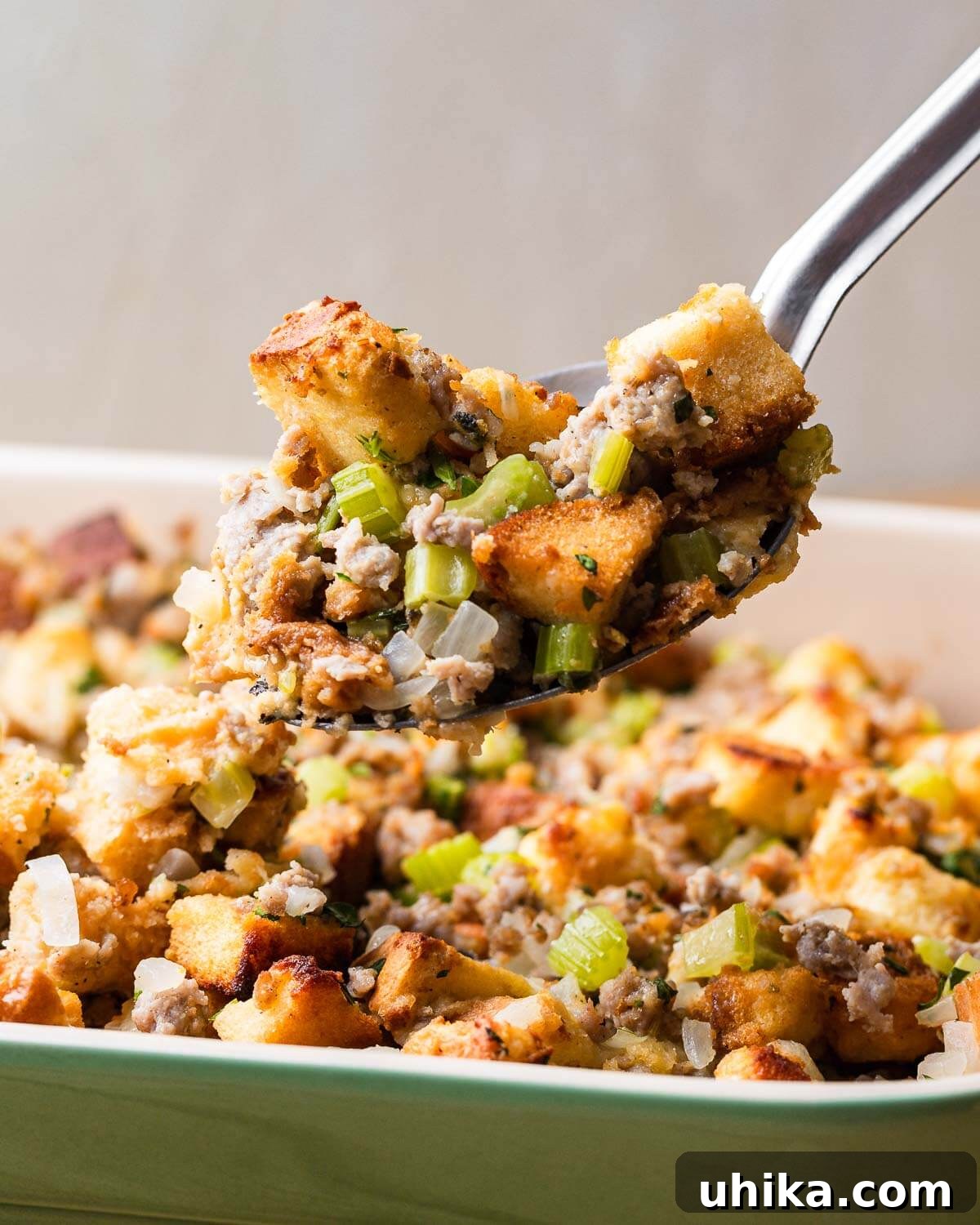 Parmesan-Infused Italian Sausage Stuffing 8 Spoon holding big scoop of sausage stuffing.