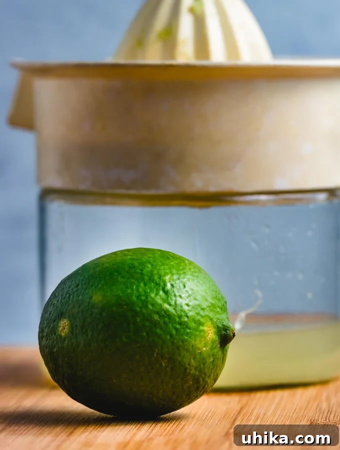 Star-Crossed Elixir 4 A close-up of fresh lime being juiced, highlighting the importance of fresh ingredients for the cocktail.
