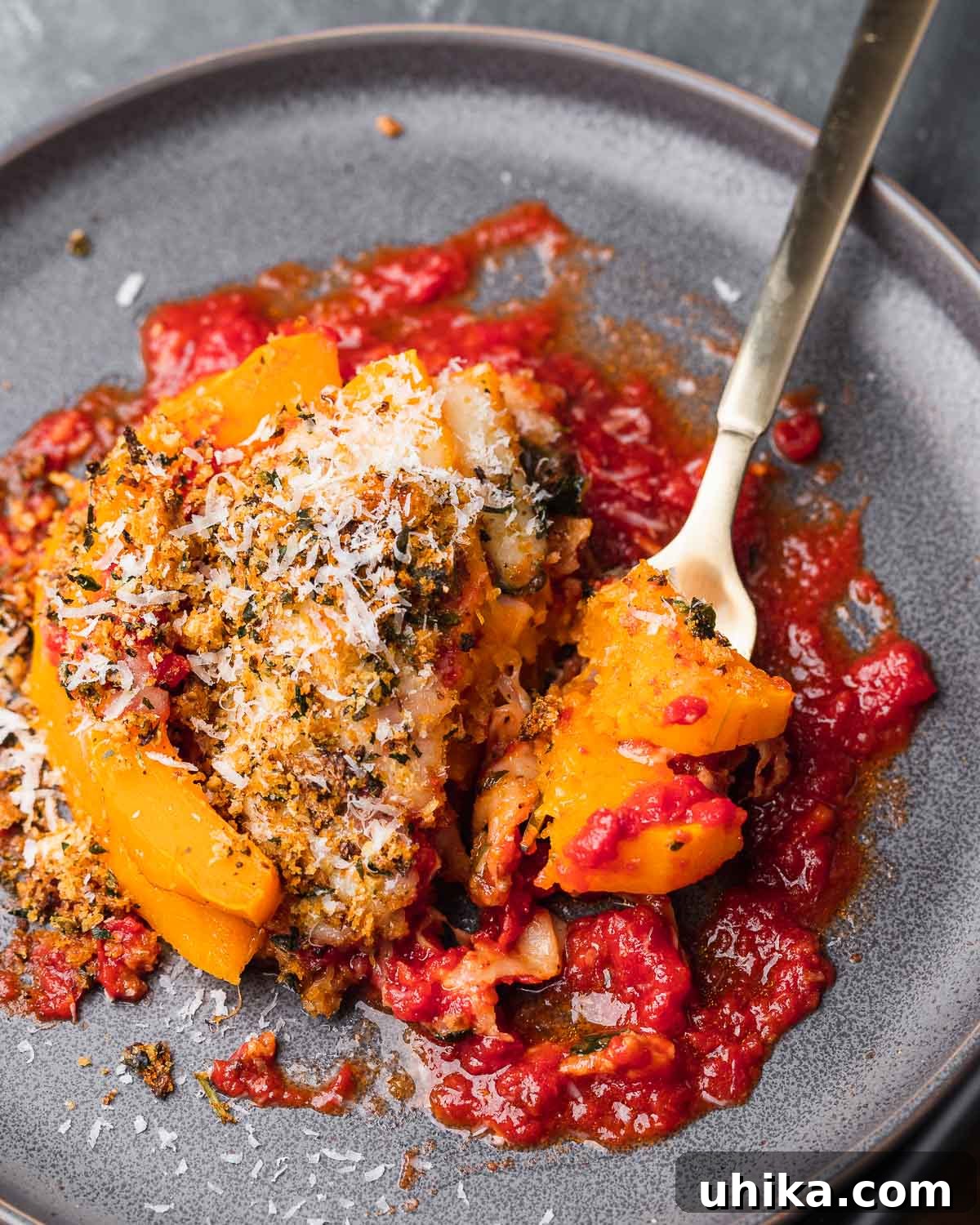 Autumn Squash Parmesan Bake 2 Butternut squash parmigiana in grey plate with fork holding piece.