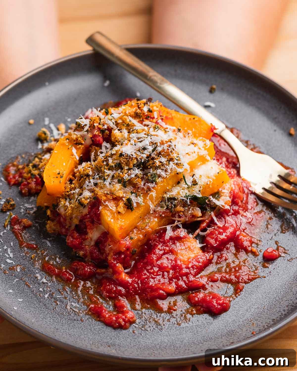 Autumn Squash Parmesan Bake 10 Hands holding plate of butternut squash parm.
