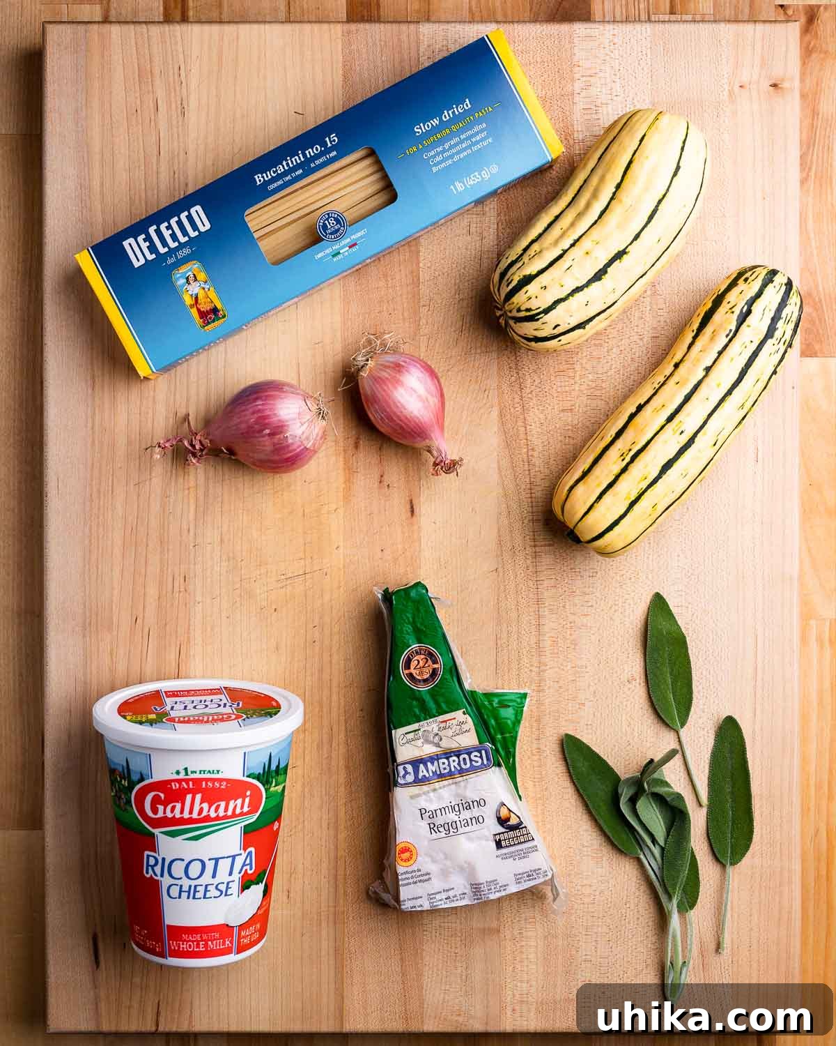 Ingredients shown: bucatini pasta, shallots, delicata squash, ricotta, parmesan, and sage leaves.