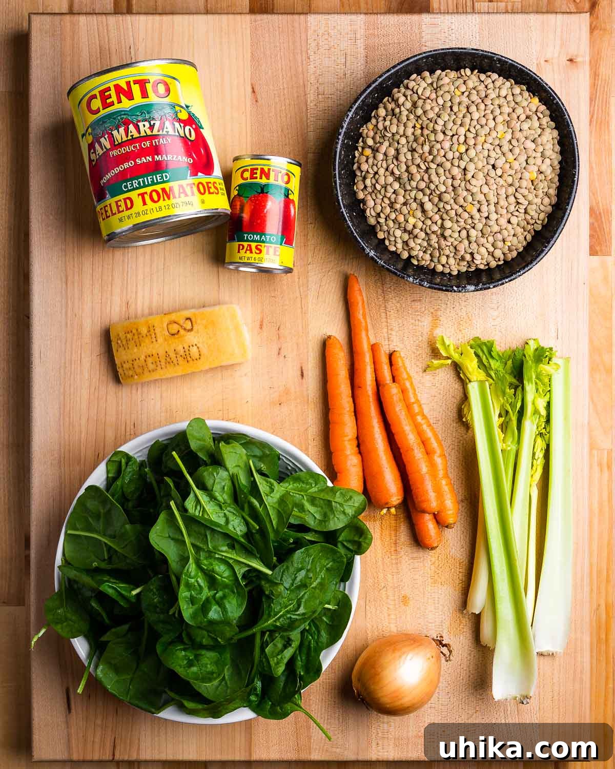 Hearty Italian Lentil Soup 2 Ingredients shown: plum tomatoes, tomato paste, lentils, Parmigiano Reggiano rind, spinach, carrots, onion, and celery.