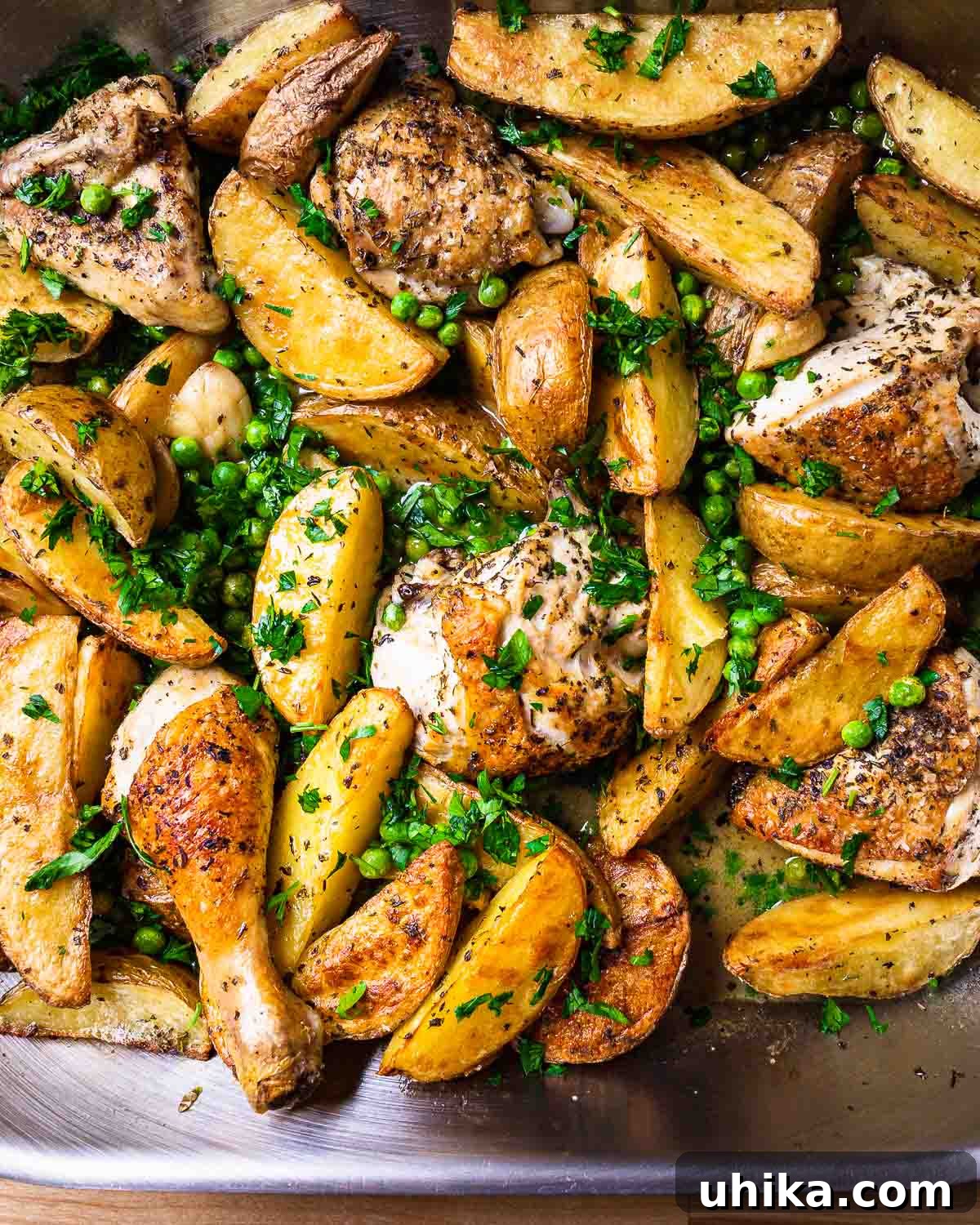 Italian Roasted Chicken & Potatoes 7 Overhead view of Chicken Vesuvio, freshly baked and served in a roasting pan, ready to be enjoyed.