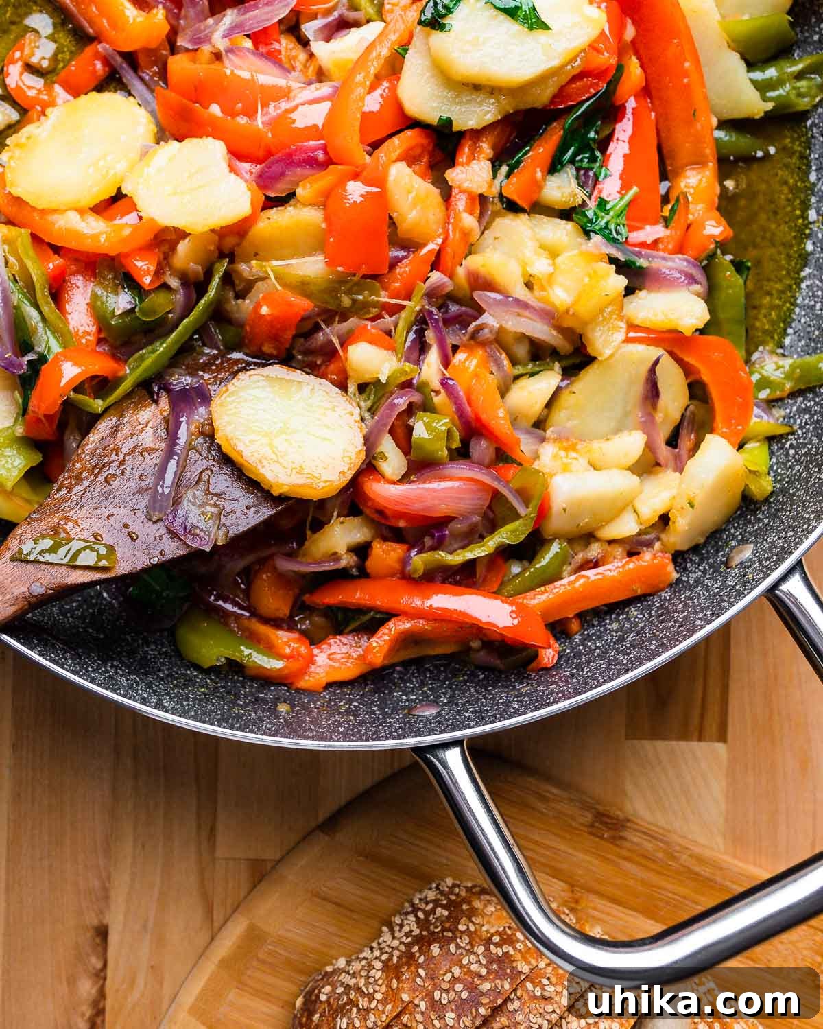 Calabrian Potatoes and Peppers 8 A large pan of freshly cooked Calabrian potatoes and peppers, served with a side of crusty Italian bread, ready to be enjoyed.