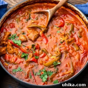 Hearty Italian Veal and Peppers stew in a large braiser, garnished with fresh parsley.