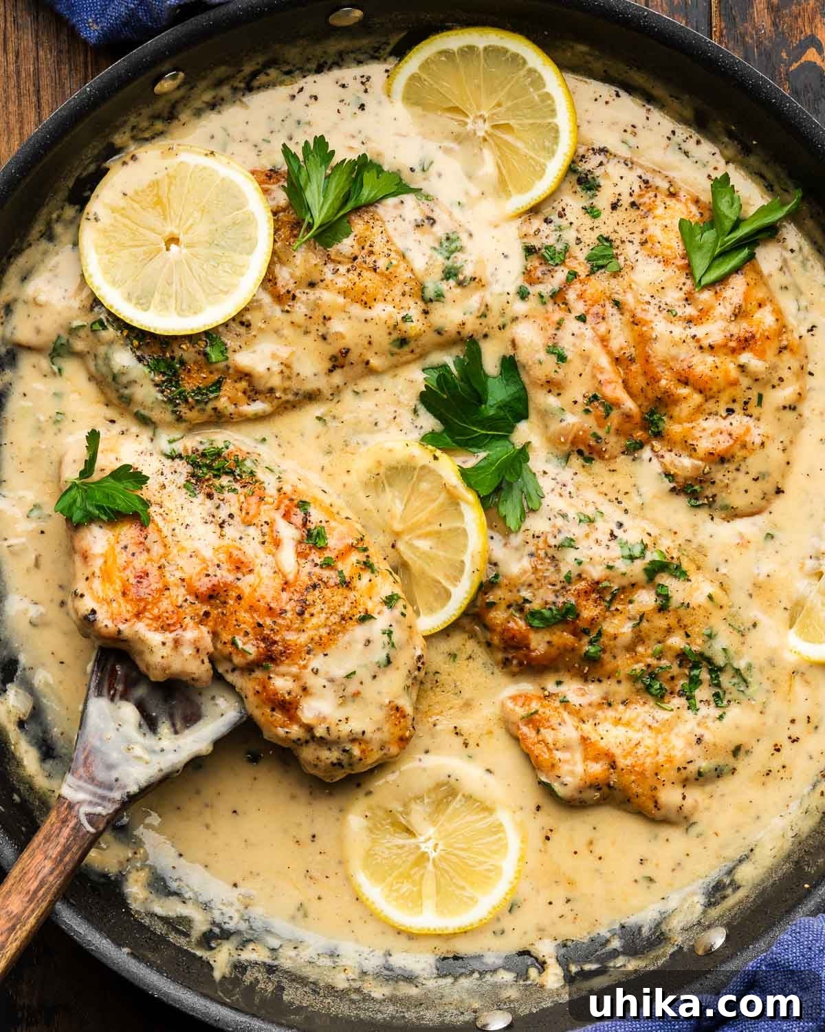 Zesty Lemon Pepper Chicken in Minutes 2 Large pan with golden seared chicken in a creamy lemon pepper sauce, garnished with fresh parsley.