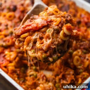 Baked Anelletti from Sicily 7 Spoon grabbing large section of anelletti al forno.