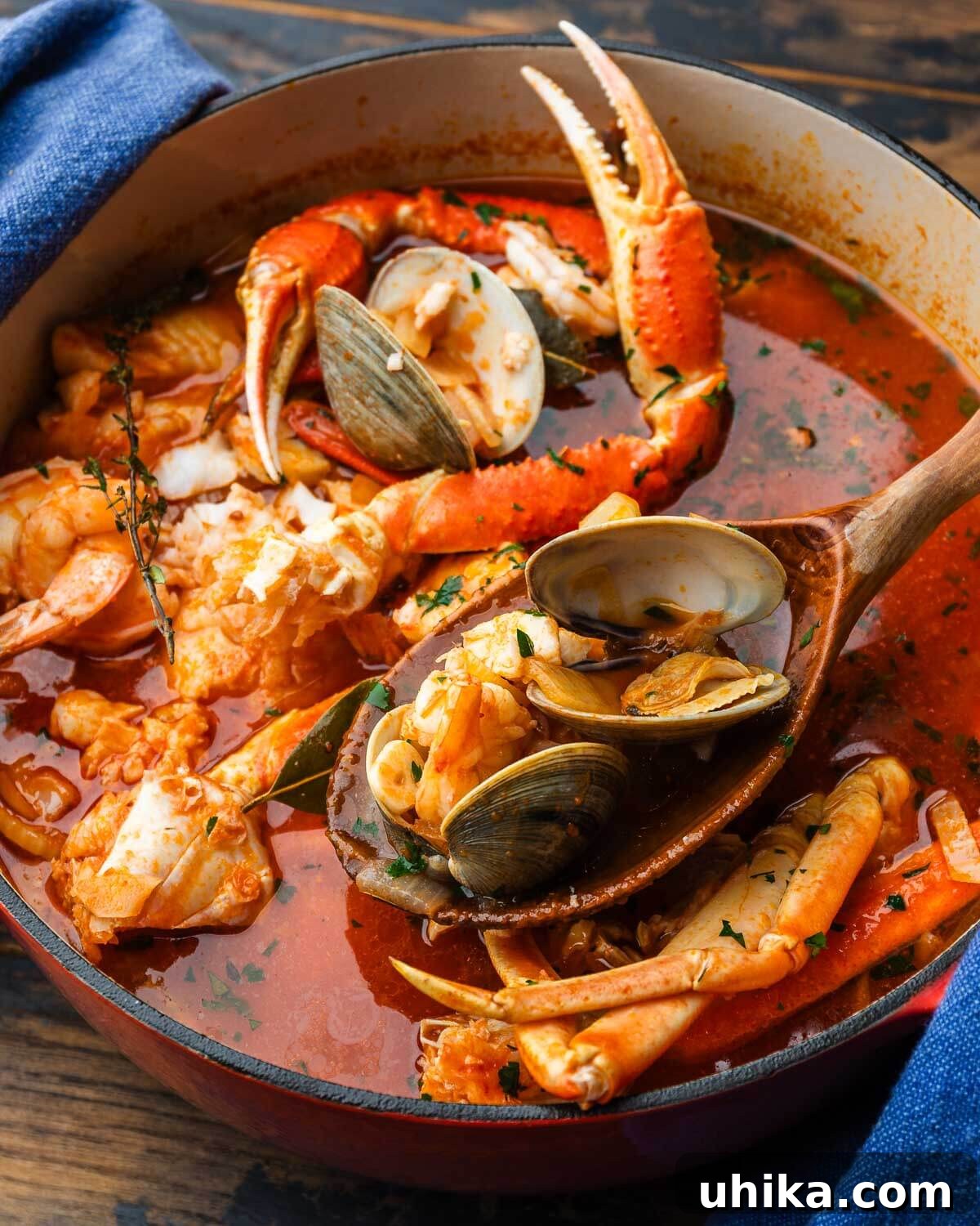Cioppino A Robust Maritime Feast 2 Wooden ladle holding clams and shrimp above a steaming pot of vibrant red cioppino, garnished with fresh herbs.