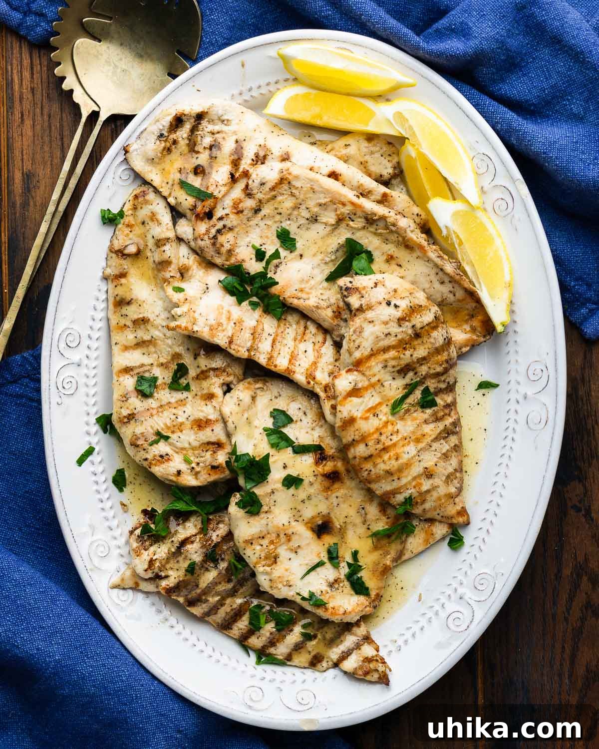 Effortlessly Delicious Marinated Grilled Chicken 2 Platter of marinated grilled chicken with lemon wedges.
