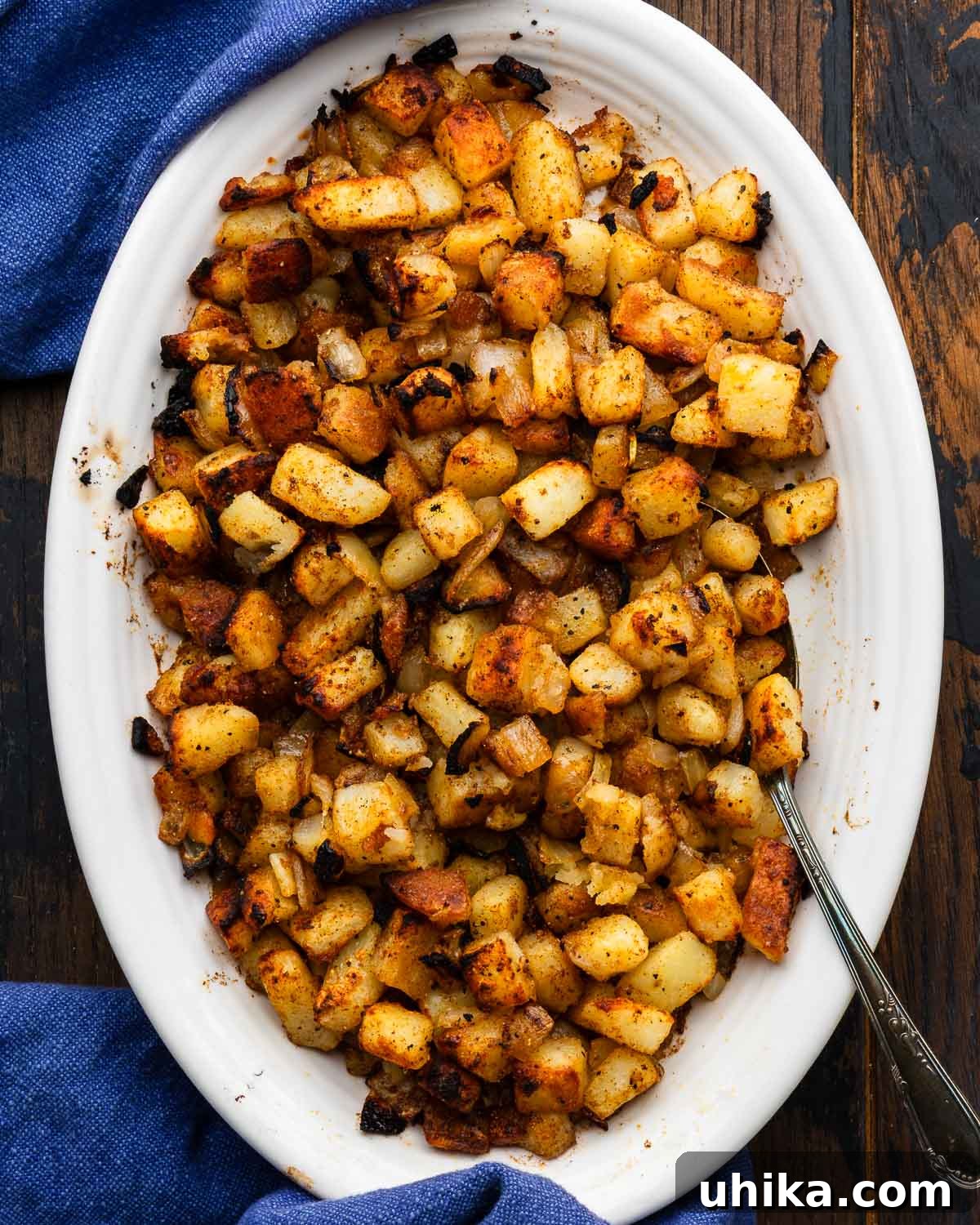 Steakhouse Skillet Potatoes 2 Steakhouse homefries in white platter.