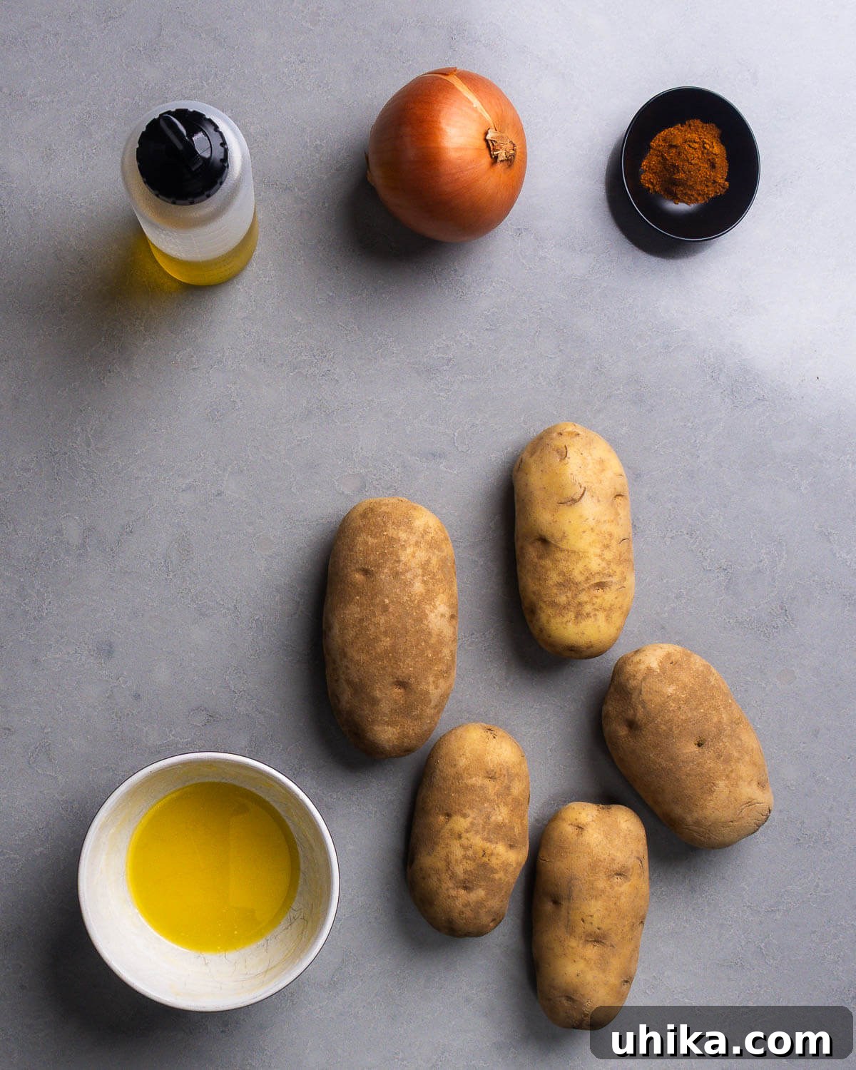Steakhouse Skillet Potatoes 4 Ingredients shown: neutral oil, onion, paprika, ghee, and russet potatoes.