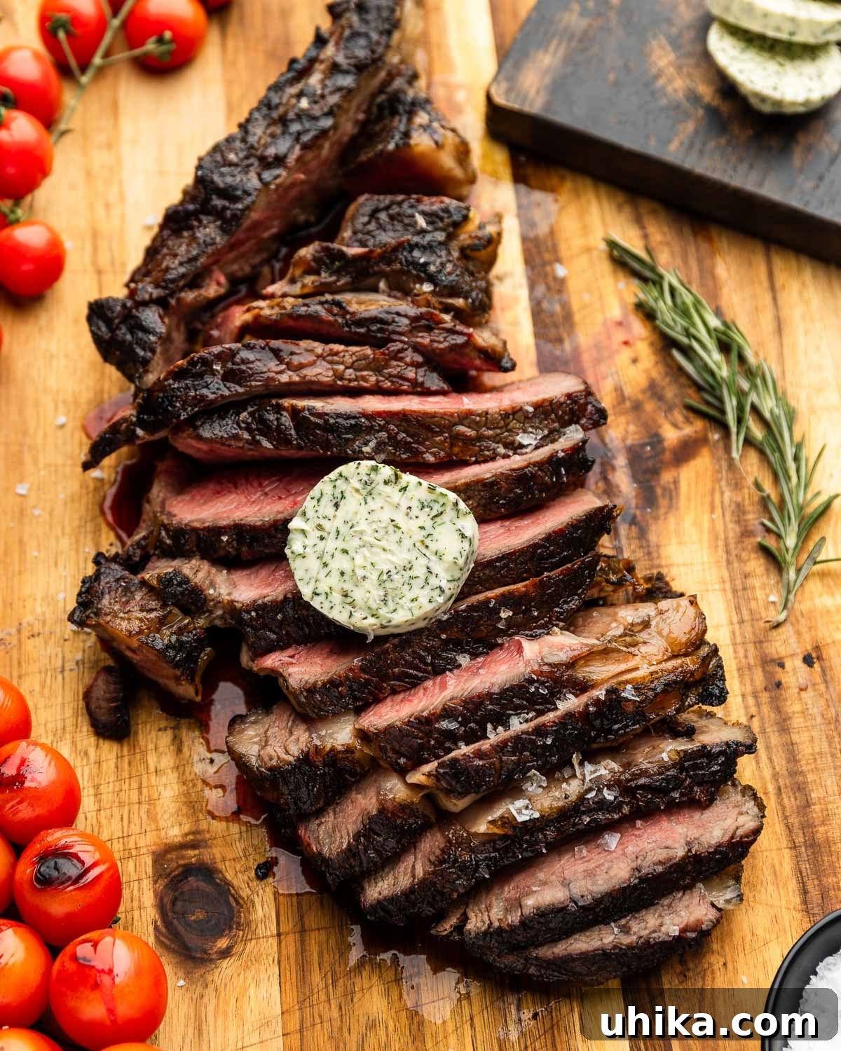 Tomahawk Steak: Grill It Like a Pro 2 Sliced grilled tomahawk steak topped with compound butter and flaky sea salt, ready to serve.