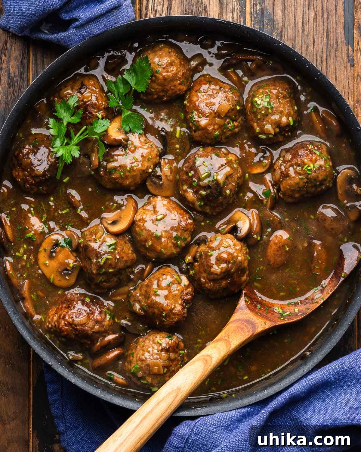 Marsala Meatballs with Creamy Mushroom Sauce 2 Large black pan with marsala meatballs topped with parsley.