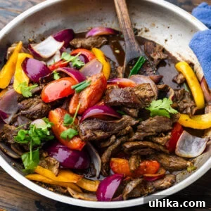 Lomo Saltado: Classic Peruvian Beef Stir-Fry Recipe 7 Large pan with lomo saltado topped with cilantro.