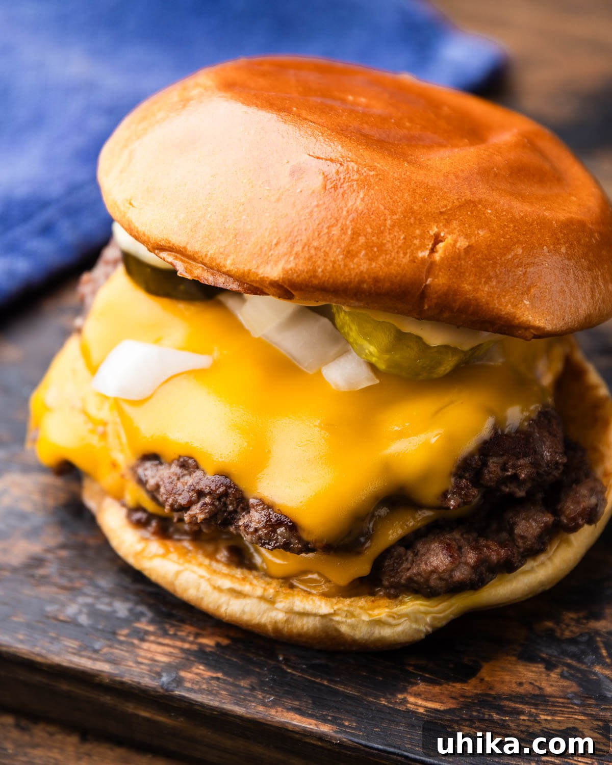 Crispy Smash Burgers with Zesty Signature Sauce 2 Smash burger on wooden board.