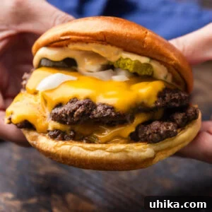 Crispy Smash Burgers with Zesty Signature Sauce 7 Hands holding a smash burger.
