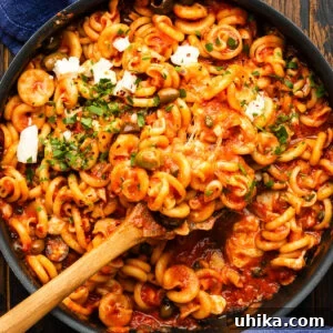 Pasta alla Vesuviana: Fiery Neapolitan Pasta 7 Spoon scooping the pasta vesuviana out of the pan.