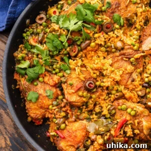 Arroz con Pollo: Spanish-Style Chicken and Rice 7 Arroz con pollo in black pan.