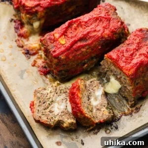 Mini Italian-Style Stuffed Meatloaves 7 Mini stuffed meatloaf cut open showing the melty cheese.