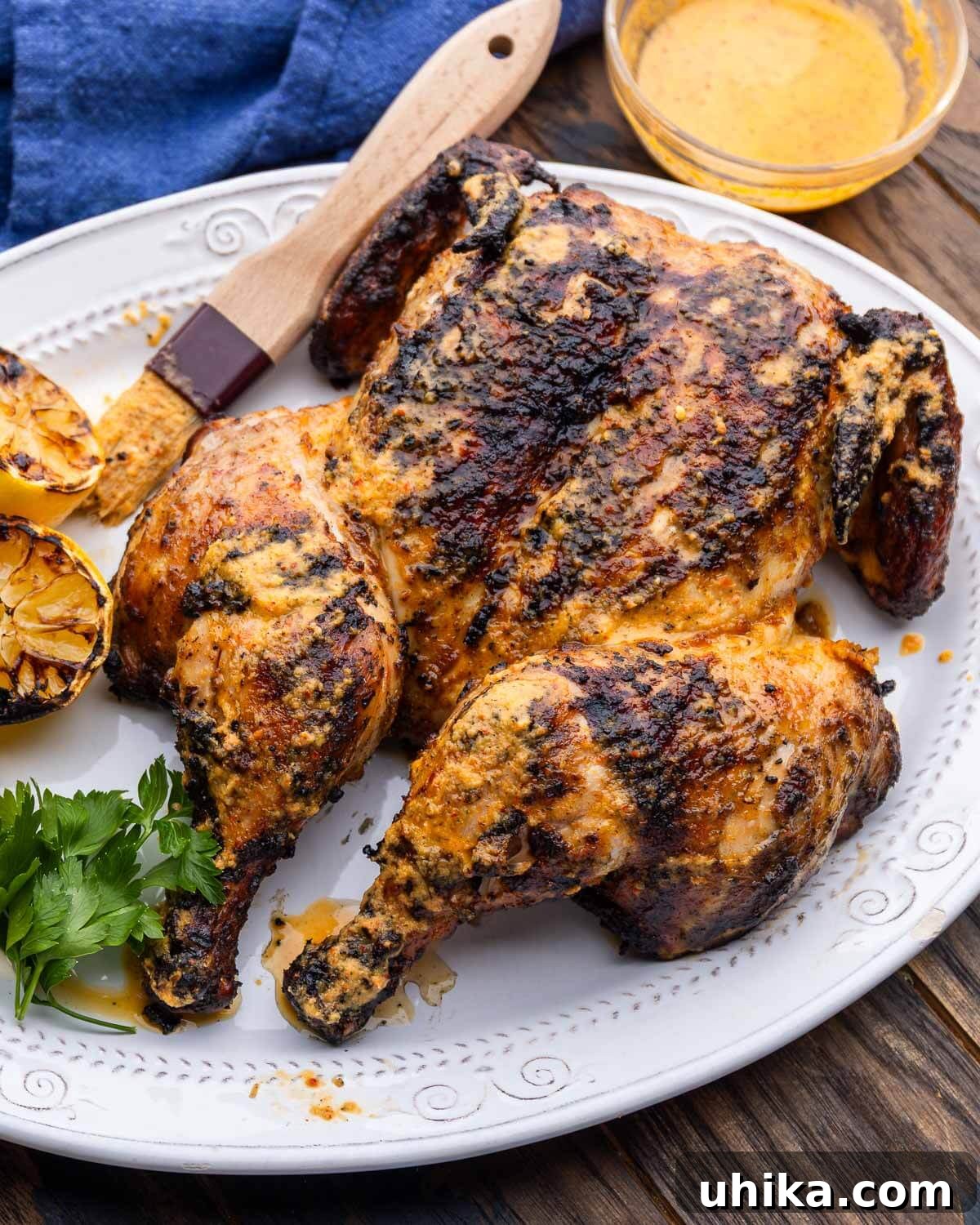 Authentic Peri-Peri Chicken Recipe with Fiery Marinade 2 Grilled peri peri chicken on platter.