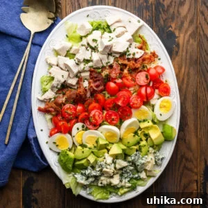 Hearty Cobb Salad Recipe with Avocado and Bacon 7 Cobb salad on white platter.