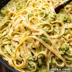 Garlic broccoli alfredo in large black pan.